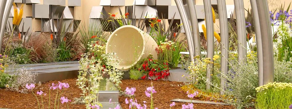 Stainless steel arches, water rill and folded wall panels in an RHS show garden